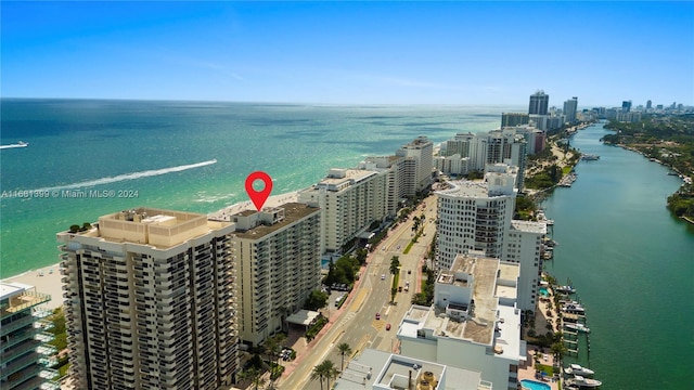 birds eye view of property featuring a view of city and a water view