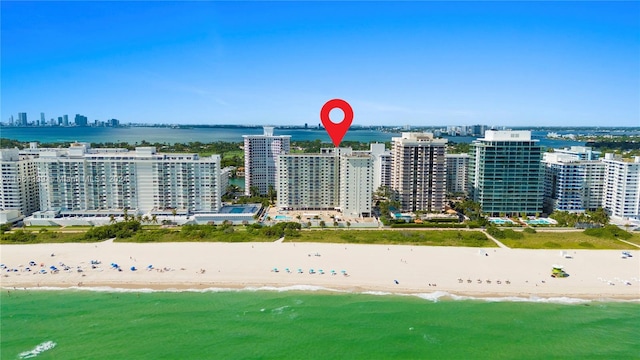 bird's eye view with a water view and a beach view