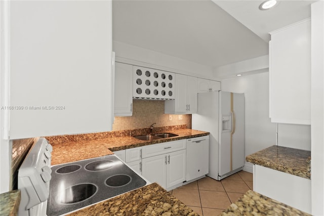 kitchen featuring a sink, white appliances, white cabinetry, decorative backsplash, and light tile patterned floors