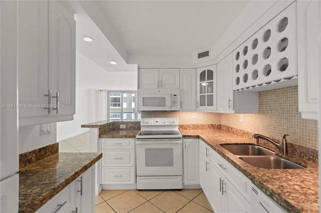 kitchen with white appliances, light tile patterned floors, visible vents, and a sink