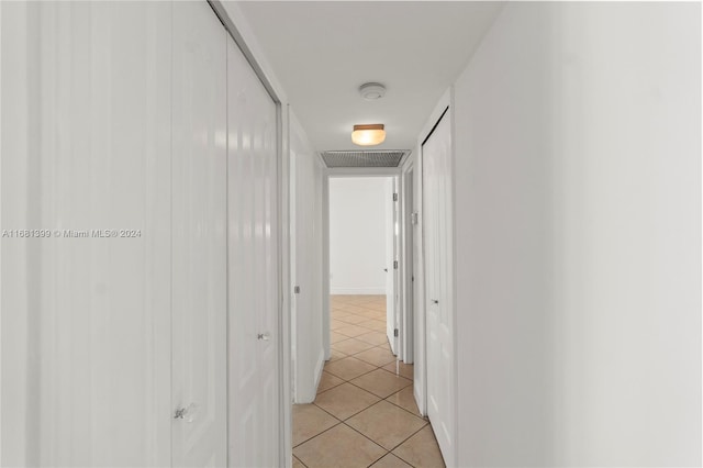 hallway with visible vents and light tile patterned floors