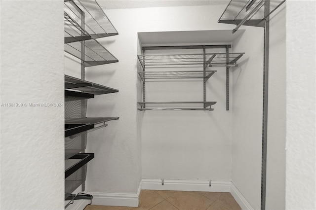 walk in closet with tile patterned flooring