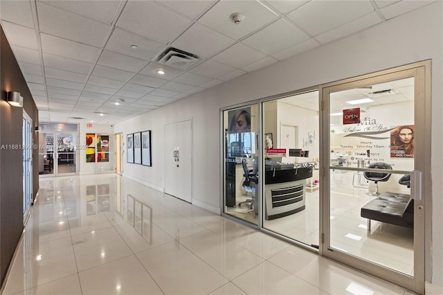 interior space with tile patterned floors, visible vents, and a paneled ceiling