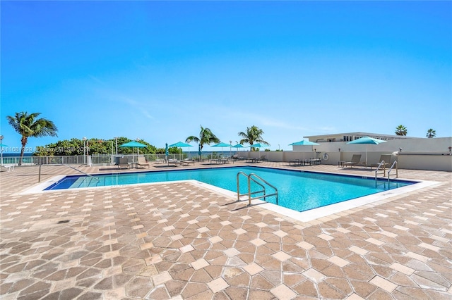 pool with fence and a patio area
