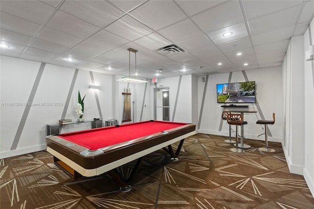 rec room with a drop ceiling, dark colored carpet, and pool table