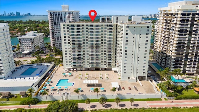 birds eye view of property with a water view and a city view