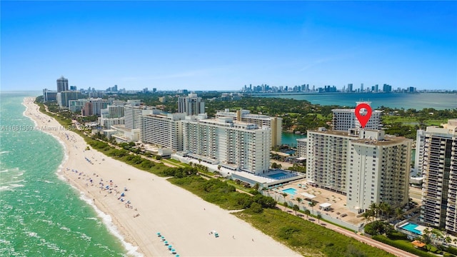 bird's eye view featuring a water view, a city view, and a view of the beach