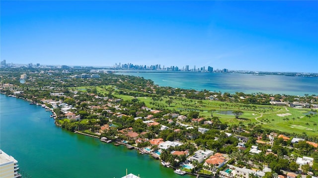 birds eye view of property featuring a view of city and a water view