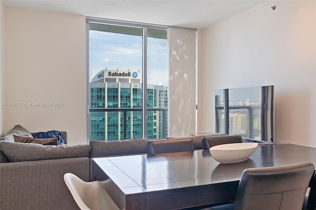 dining room with a healthy amount of sunlight and floor to ceiling windows