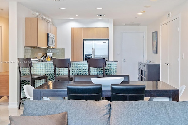 dining area featuring light tile patterned floors