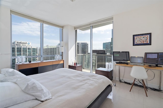 bedroom featuring expansive windows and light tile patterned floors