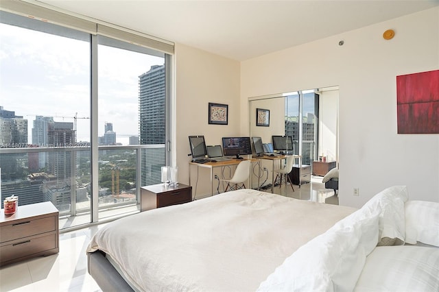 tiled bedroom with a wall of windows, multiple windows, and access to outside