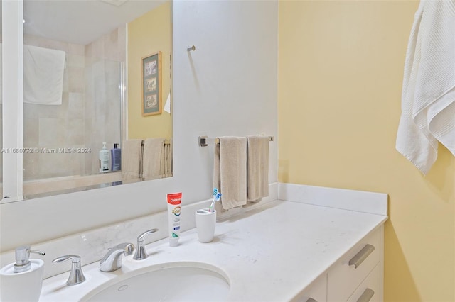 bathroom with vanity and a shower with shower door