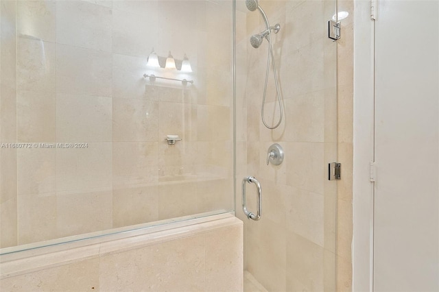 bathroom with a shower with door