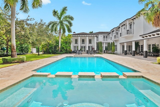 view of pool with an in ground hot tub, french doors, and a patio