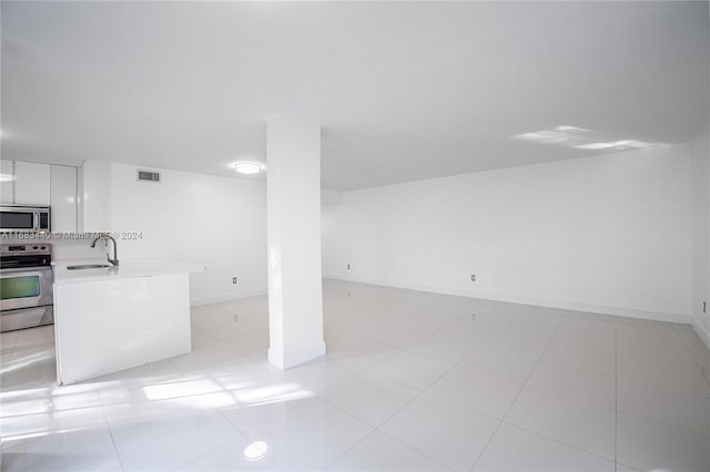 interior space featuring sink and light tile patterned floors