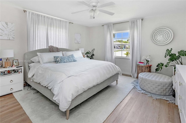 bedroom with ceiling fan and light wood-type flooring