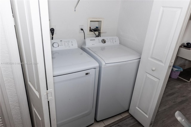 laundry area featuring dark hardwood / wood-style flooring and washer and clothes dryer