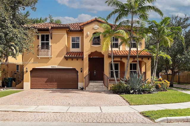 mediterranean / spanish home featuring a garage