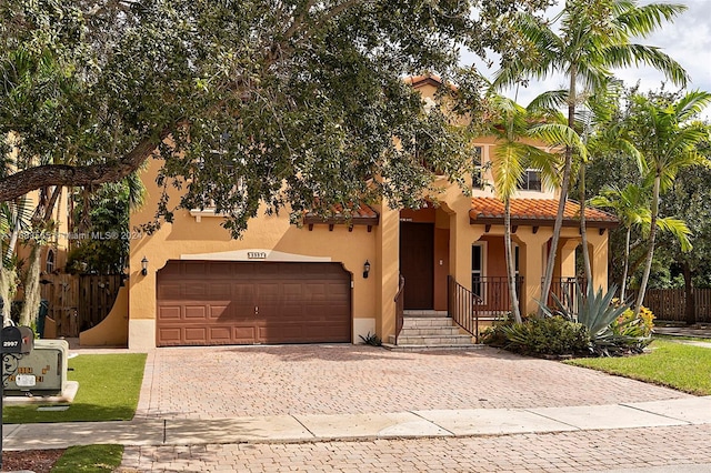 mediterranean / spanish-style house with a garage