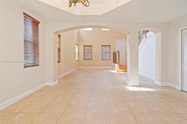 interior space featuring light tile patterned flooring and an inviting chandelier