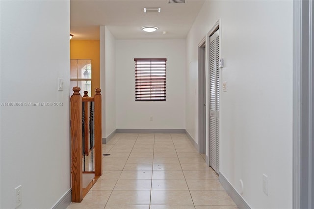 corridor featuring light tile patterned flooring