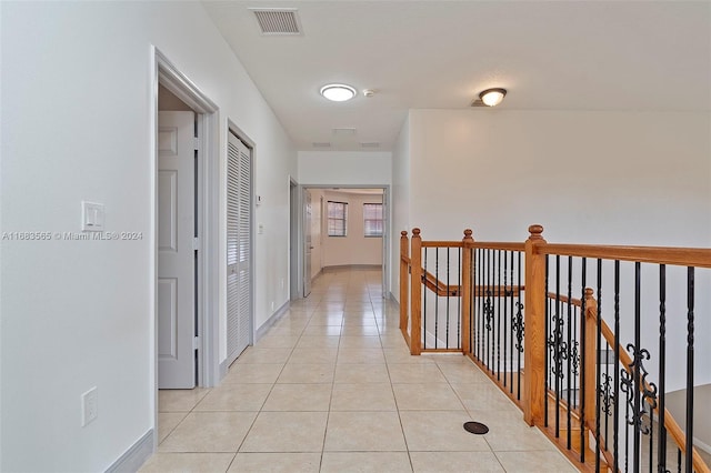 hall featuring light tile patterned floors