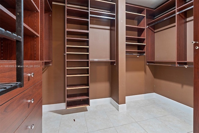 spacious closet featuring tile patterned flooring