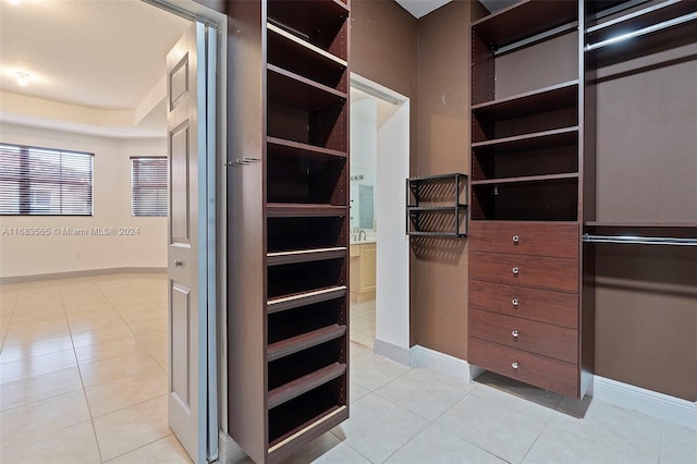 walk in closet featuring light tile patterned flooring