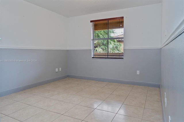 unfurnished room featuring light tile patterned floors