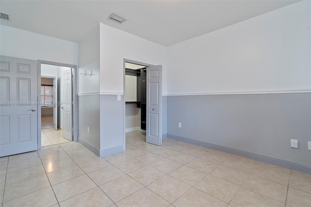 unfurnished bedroom featuring light tile patterned floors