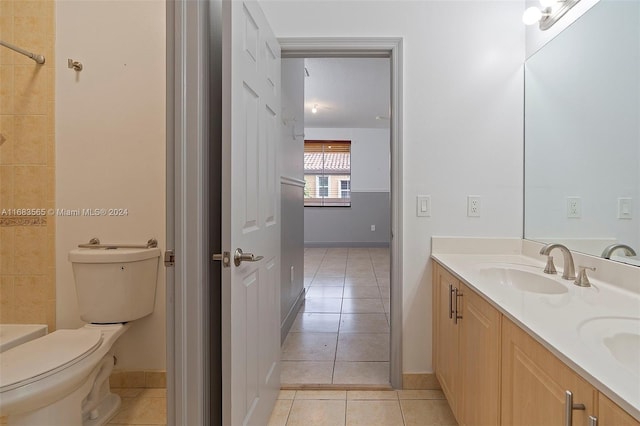 bathroom with toilet, vanity, a washtub, and tile patterned flooring