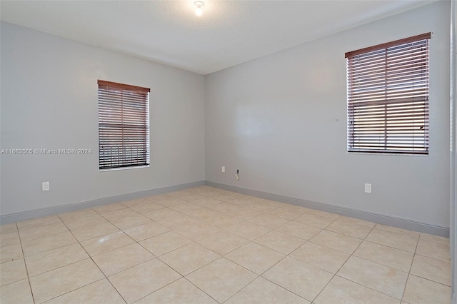 spare room featuring light tile patterned flooring