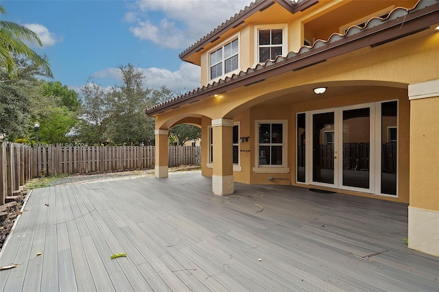 wooden deck with a wall mounted air conditioner