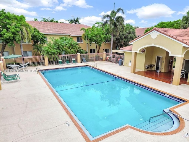 view of swimming pool with a patio area