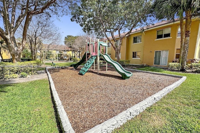 community jungle gym with a lawn