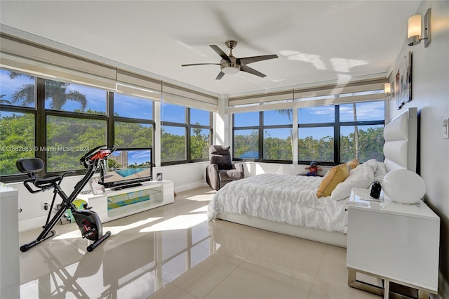 tiled bedroom with ceiling fan and multiple windows