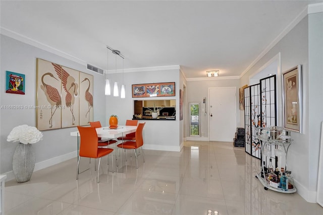 dining room featuring crown molding and light tile patterned floors