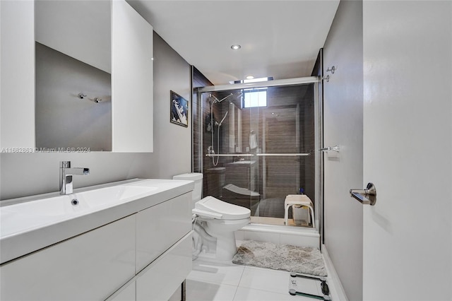 bathroom featuring vanity, toilet, tile patterned floors, and a shower with door