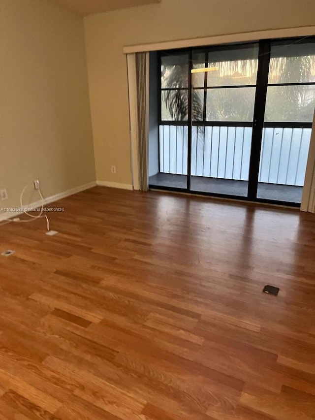 spare room featuring wood-type flooring