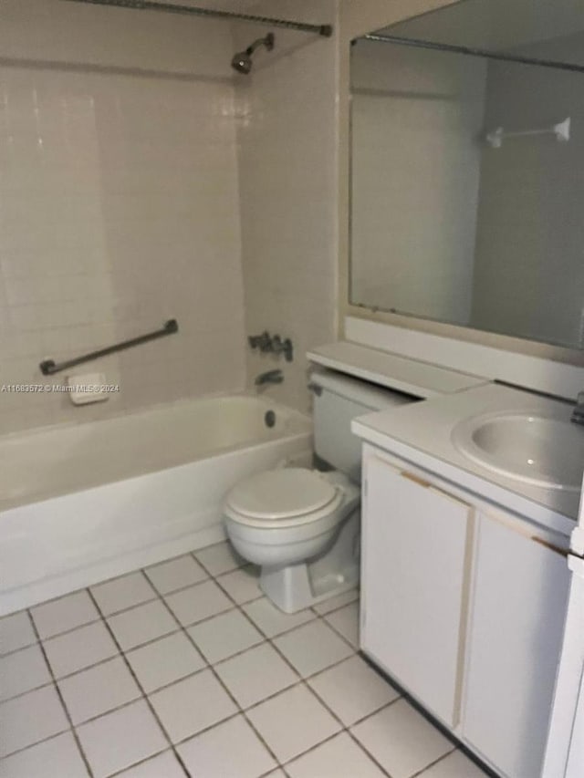 full bathroom featuring tile patterned flooring, tiled shower / bath combo, toilet, and vanity