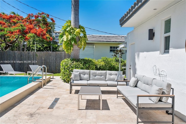 view of patio / terrace featuring an outdoor living space and a fenced in pool