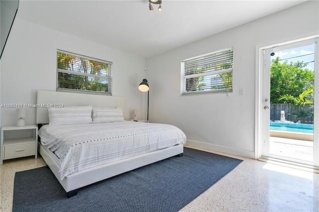 bedroom with multiple windows and access to exterior