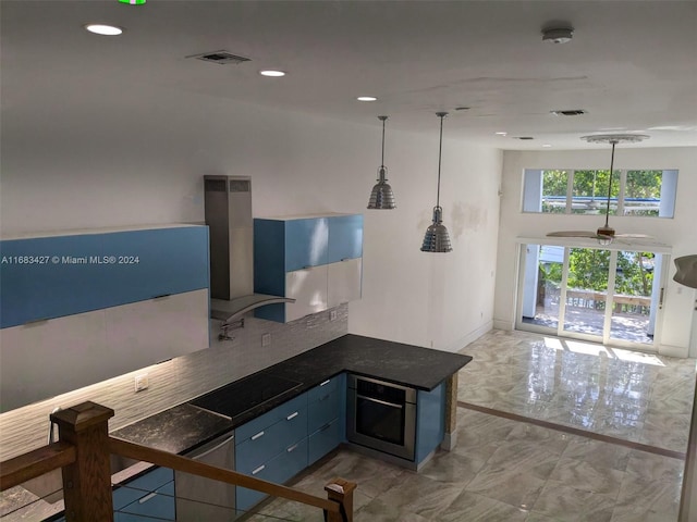 kitchen featuring black electric cooktop, extractor fan, kitchen peninsula, blue cabinets, and ceiling fan