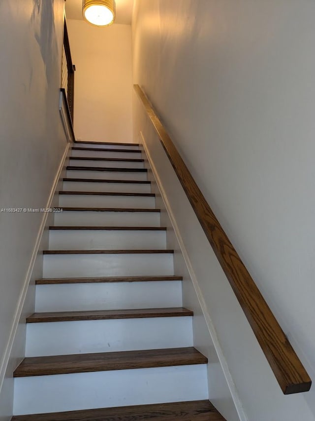 stairs with hardwood / wood-style flooring