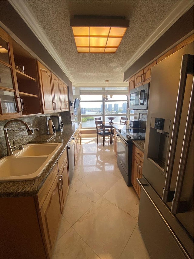 kitchen with tasteful backsplash, sink, a textured ceiling, stainless steel appliances, and crown molding