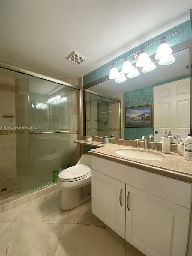 bathroom with vanity, walk in shower, and toilet