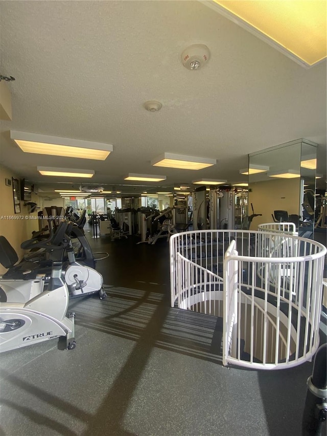 gym featuring a textured ceiling