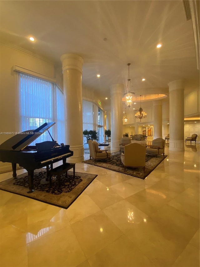 miscellaneous room featuring an inviting chandelier, ornamental molding, tile patterned floors, and ornate columns