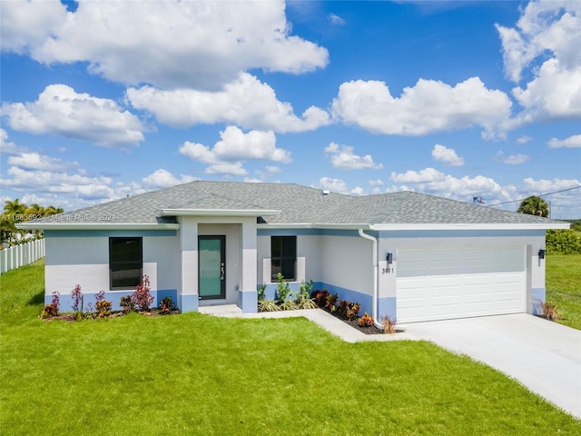 view of front of house featuring a front yard and a garage